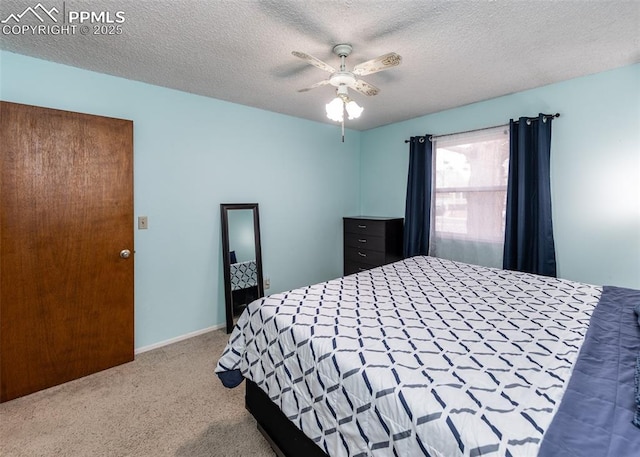 bedroom with carpet, a textured ceiling, and ceiling fan