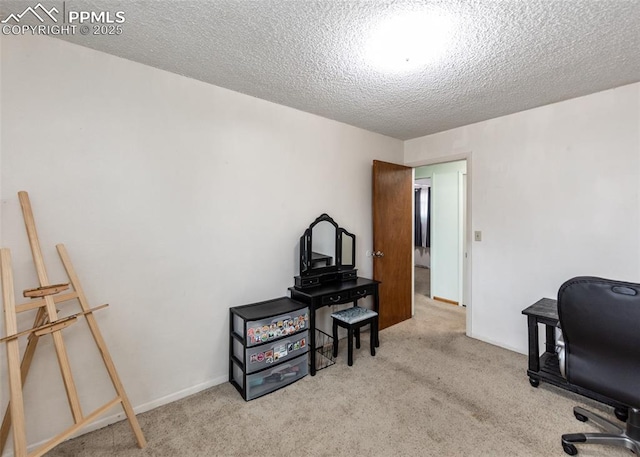 carpeted home office with a textured ceiling