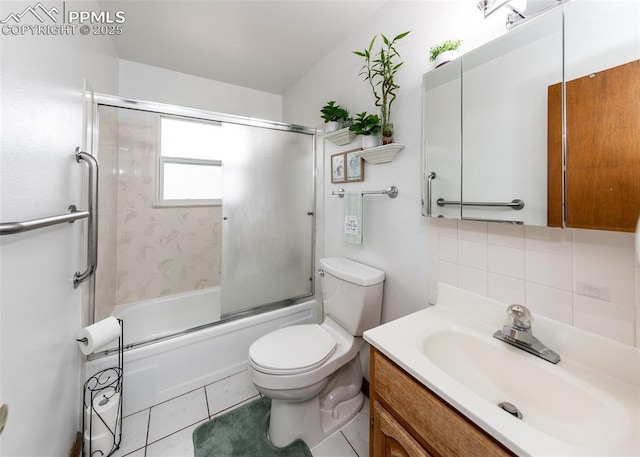 full bathroom featuring vanity, backsplash, bath / shower combo with glass door, tile patterned flooring, and toilet