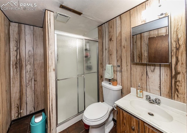 bathroom with wooden walls, vanity, and walk in shower