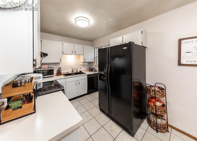 kitchen with black appliances, sink, range hood, light tile patterned flooring, and white cabinetry