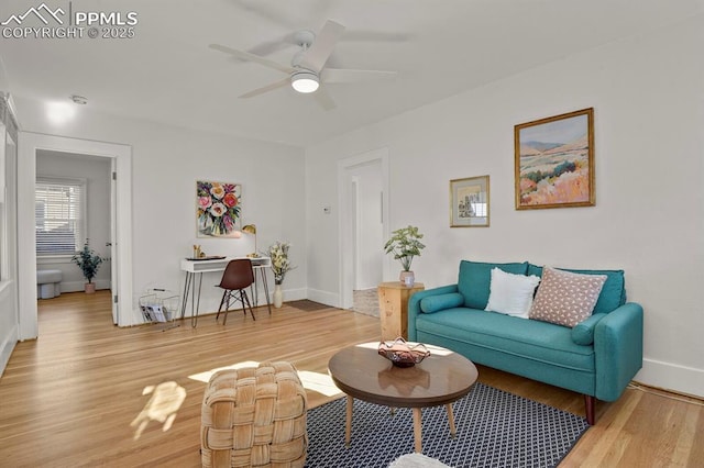 living room featuring ceiling fan and light hardwood / wood-style flooring