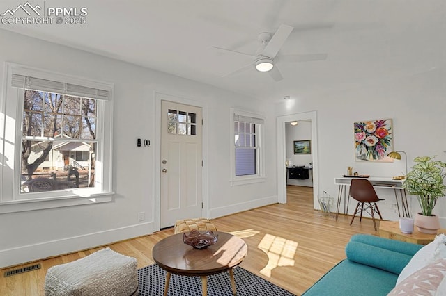 living room featuring hardwood / wood-style flooring and ceiling fan