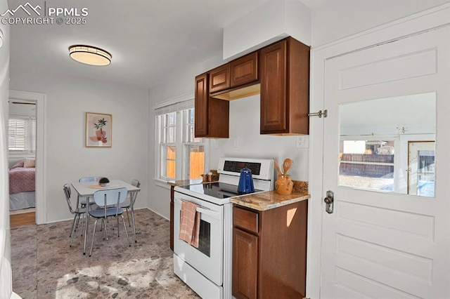 kitchen featuring electric range and light stone counters