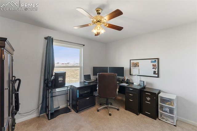 carpeted office space with ceiling fan