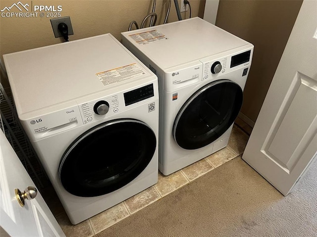 laundry area with washing machine and dryer and light carpet