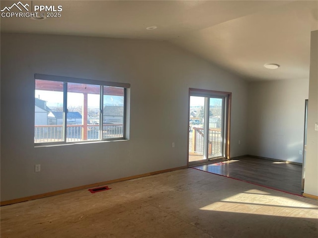 spare room featuring vaulted ceiling