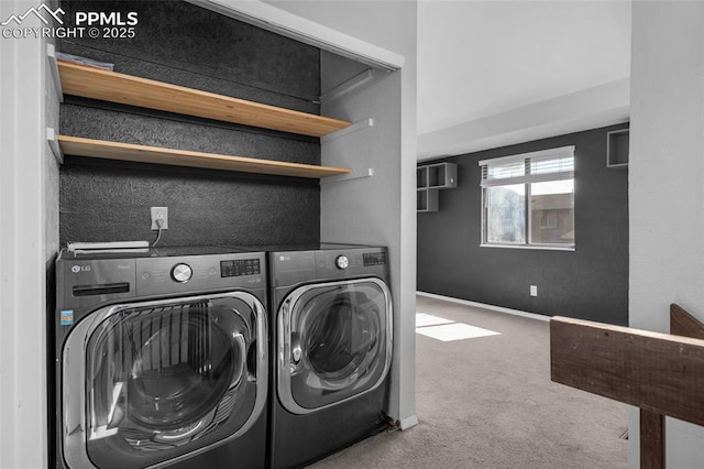 clothes washing area featuring washing machine and clothes dryer and carpet floors