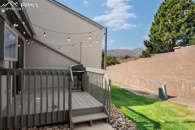 deck featuring a mountain view and grilling area