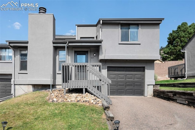 view of front of property featuring a front yard and a garage