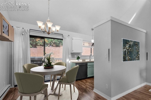 dining room with sink, wood-type flooring, a baseboard radiator, and an inviting chandelier