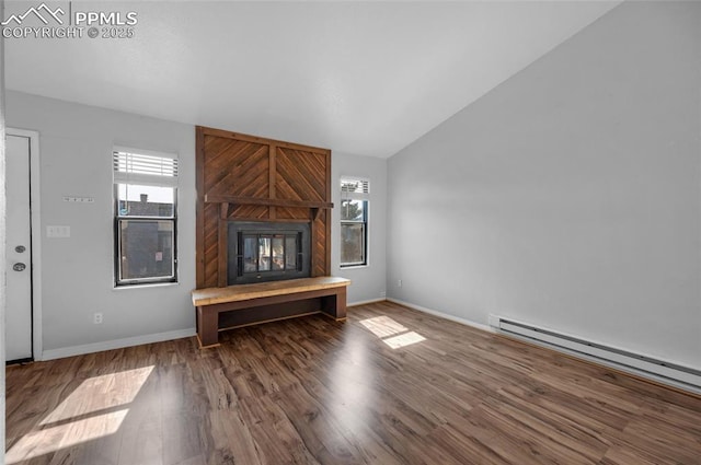 unfurnished living room with dark hardwood / wood-style floors, baseboard heating, a fireplace, and vaulted ceiling