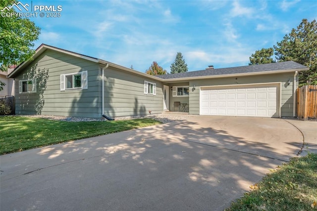 ranch-style house featuring a garage and a front yard