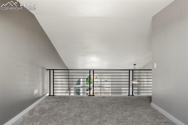 stairway with carpet floors and vaulted ceiling