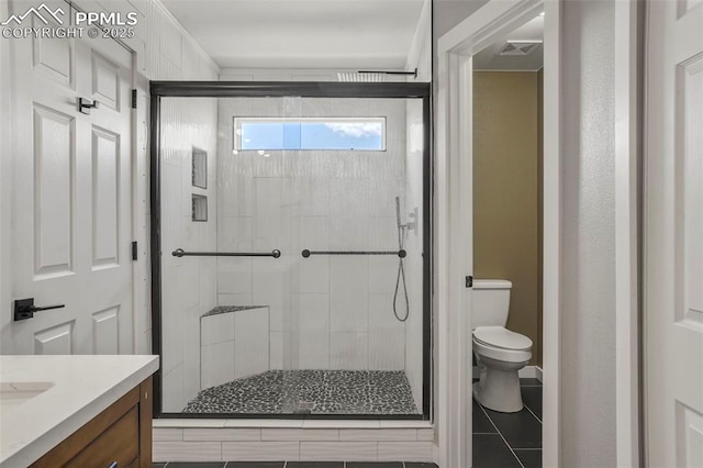 bathroom with vanity, a shower with shower door, and toilet