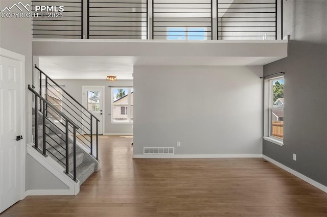 foyer entrance featuring a high ceiling and hardwood / wood-style flooring