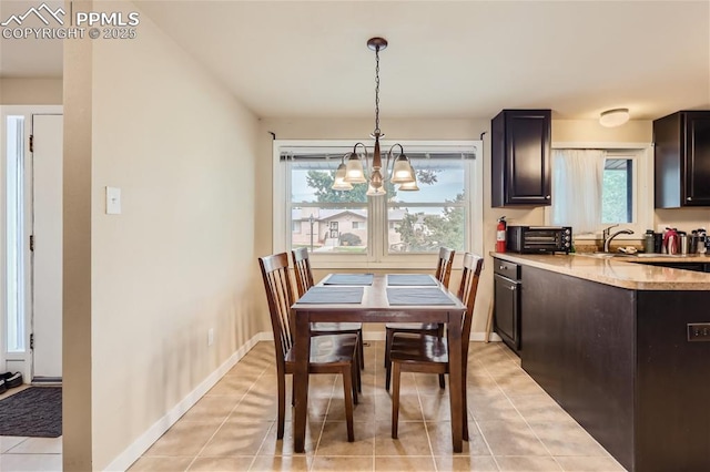 tiled dining area with sink, a wealth of natural light, and an inviting chandelier