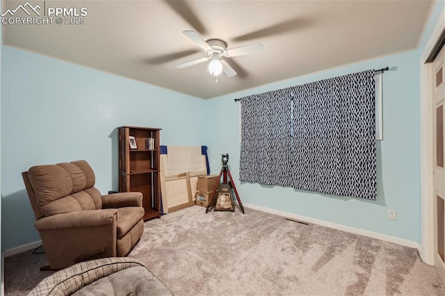 sitting room featuring ceiling fan and carpet