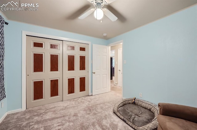 bedroom featuring ceiling fan, light carpet, and a closet