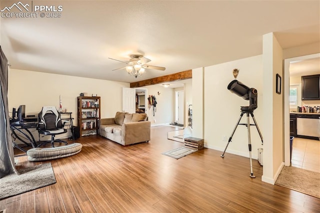 living room with ceiling fan and hardwood / wood-style flooring