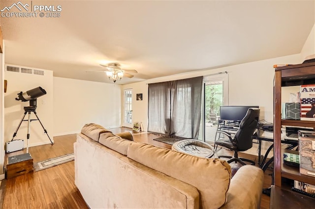 living room featuring ceiling fan and hardwood / wood-style floors