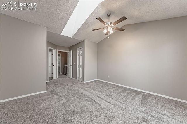 unfurnished room with carpet flooring, ceiling fan, a textured ceiling, and lofted ceiling