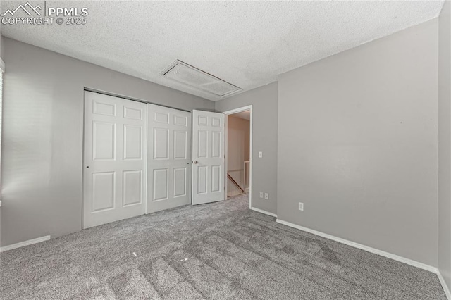 unfurnished bedroom featuring a closet, carpet floors, and a textured ceiling