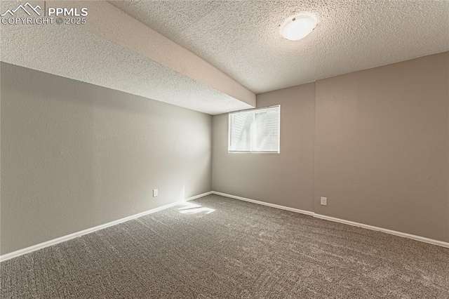 carpeted empty room with a textured ceiling