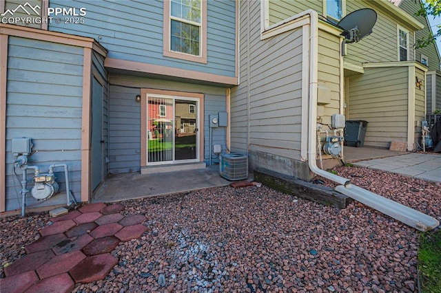 entrance to property with central air condition unit and a patio