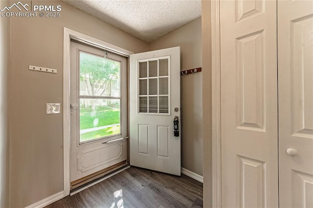 doorway featuring dark hardwood / wood-style floors and a textured ceiling