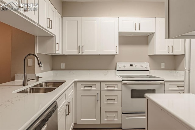 kitchen with white cabinets, electric range, and sink