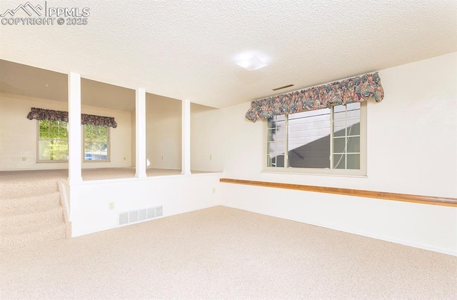 empty room featuring carpet flooring and a textured ceiling