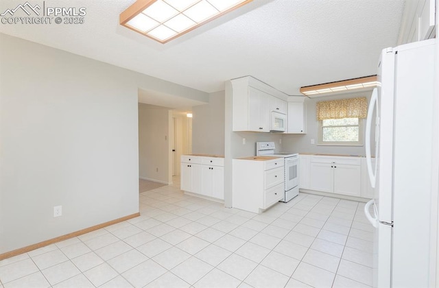 kitchen with a textured ceiling, white cabinets, light tile patterned flooring, and white appliances