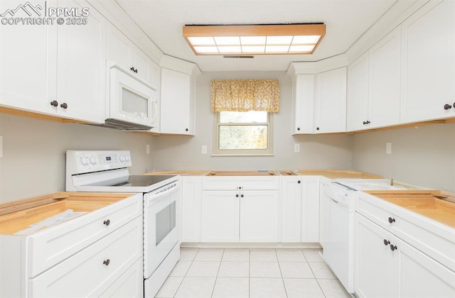 kitchen featuring white cabinetry, light tile patterned floors, and white appliances