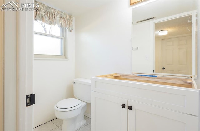 bathroom featuring tile patterned floors, vanity, and toilet