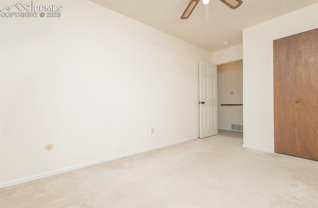 unfurnished bedroom featuring ceiling fan and light carpet