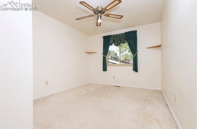 unfurnished room featuring light carpet, ceiling fan, and a textured ceiling