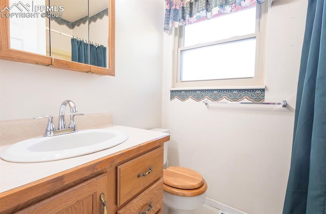 bathroom featuring vanity and toilet