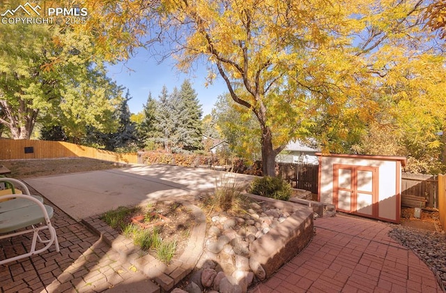 view of patio with a storage shed