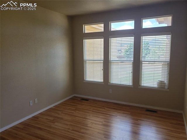 empty room with hardwood / wood-style floors