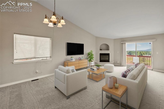 living room with light carpet, lofted ceiling, and an inviting chandelier