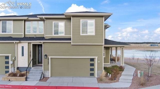 view of front of property featuring a water view and a garage