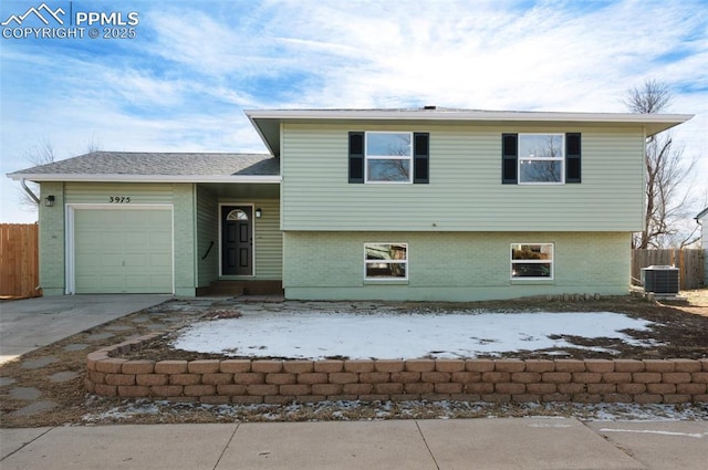 tri-level home with central AC and a garage