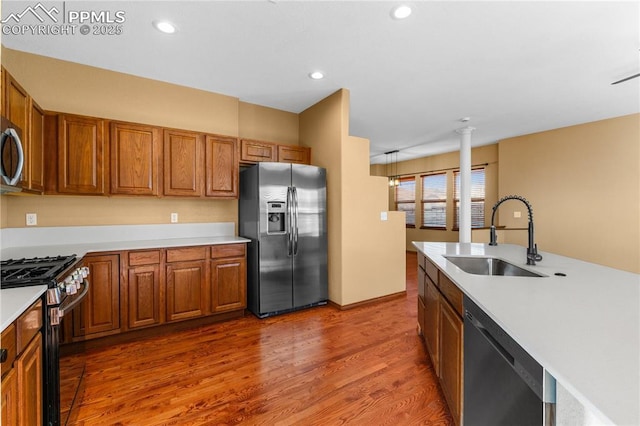 kitchen featuring dark hardwood / wood-style flooring, sink, and appliances with stainless steel finishes