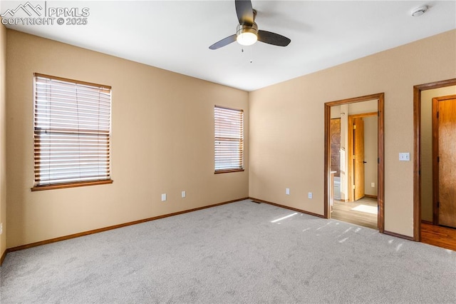 unfurnished bedroom featuring light colored carpet and ceiling fan