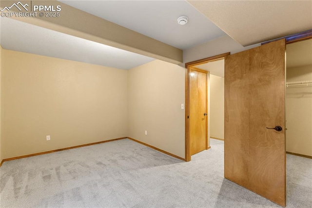 unfurnished bedroom featuring light colored carpet and a closet