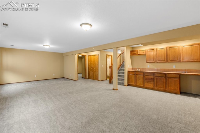 unfurnished living room featuring light colored carpet