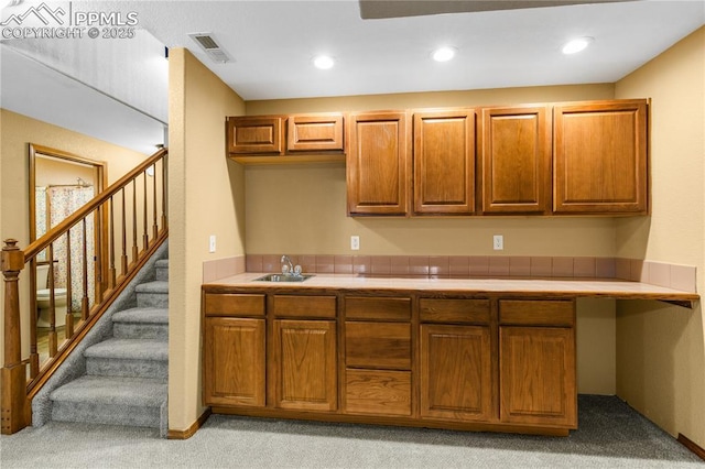 kitchen with light carpet and sink