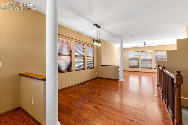 unfurnished room with hardwood / wood-style floors and ceiling fan