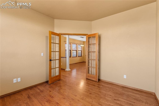 unfurnished room with french doors and light hardwood / wood-style floors